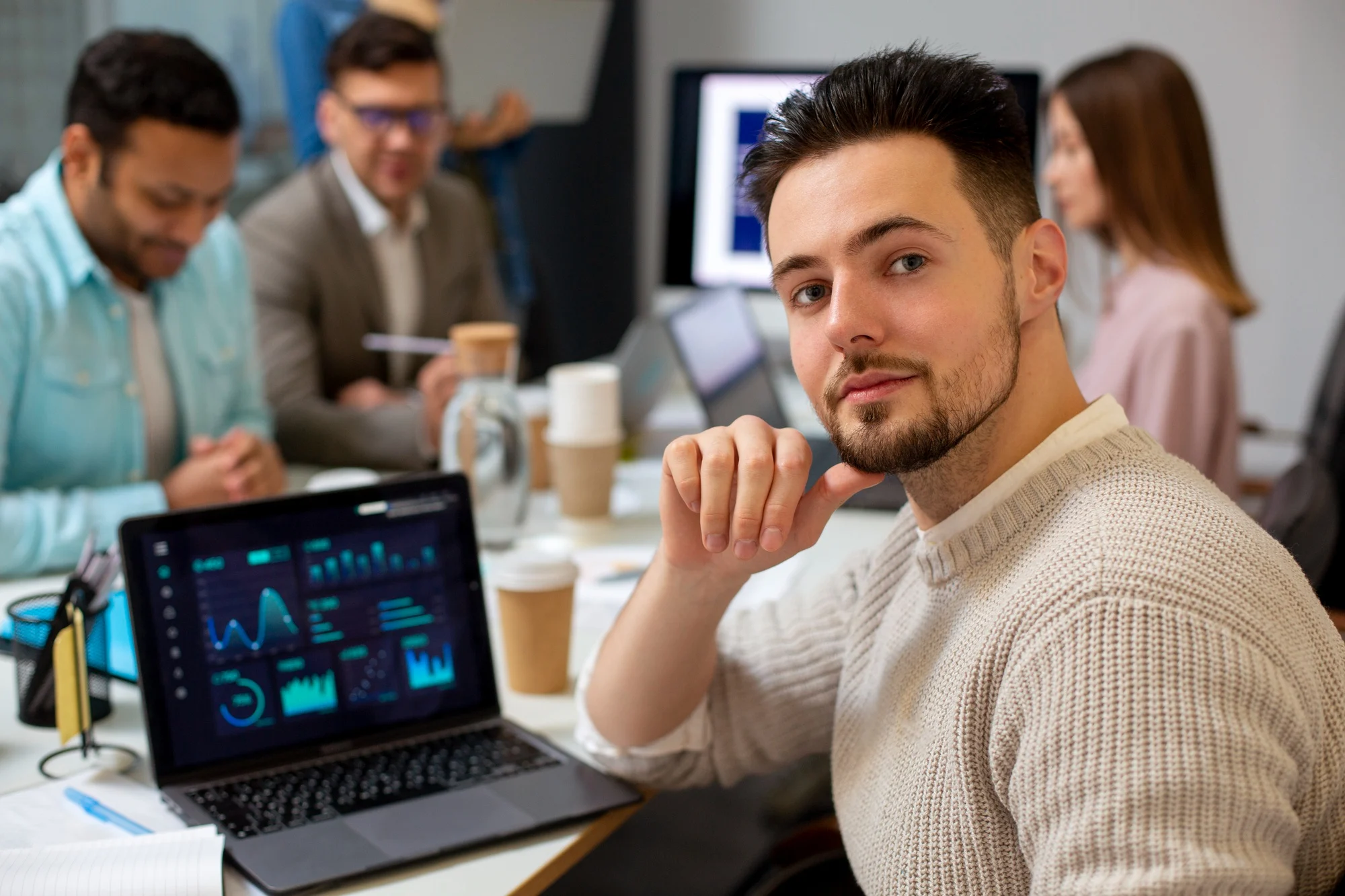 A smiling technology leader beside a connected globe in a contemporary office